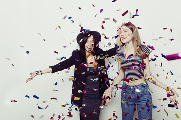 Studio lifestyle portrait of two best friends hipster girls