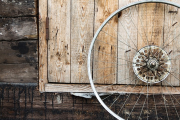 Fototapeta na wymiar old wheel from a bicycle on a wooden background