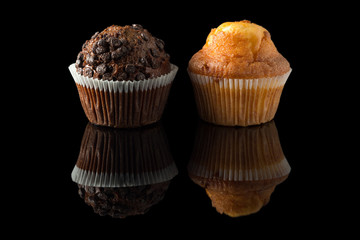 chocolate and orange muffins with reflection on black