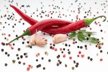 Chilli pepper with garlic and pepper on white