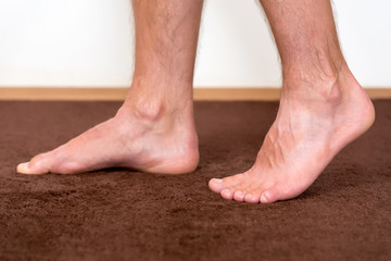Healthy male feet feeling comfortable at home.