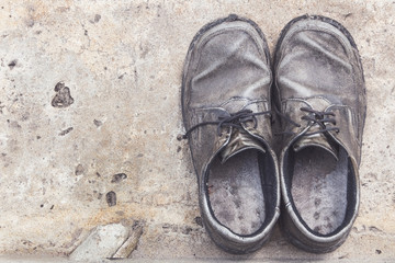 the old genuine leather shoes on concrete background