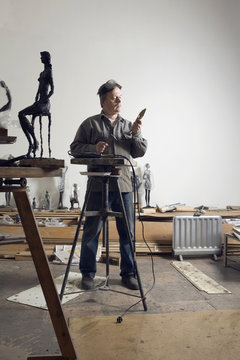 A sculptor working in an art studio