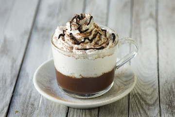 Cup Of Cappuccino With Whipeed Cream Over Wooden Table