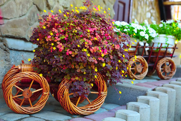 Fototapeta na wymiar Artificial flowers in a cart