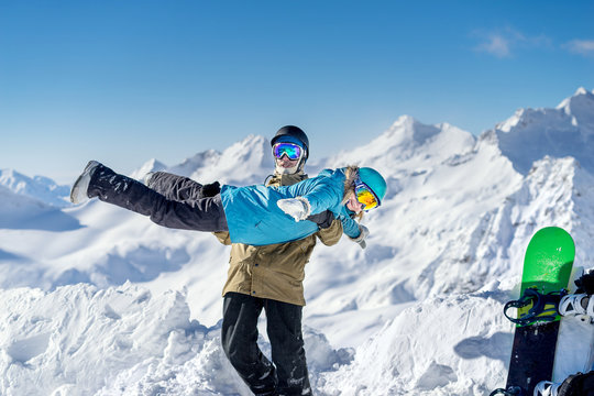 Happy young couple on background high mountains