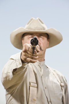 Close up of a cowboy aiming his gun