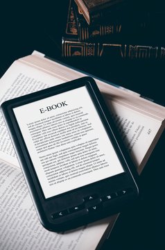 E-book reader device on desk in library