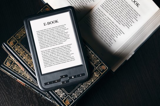 E-book reader device on desk in library