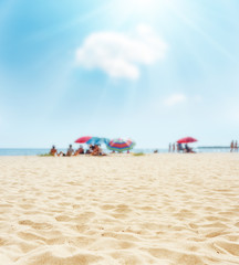Fototapeta na wymiar sand on beach closeup and sun in blue sky