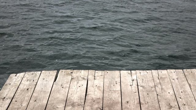 Slow motion video of Wood board table in front of lake waves. Full HD stock footage clip.
