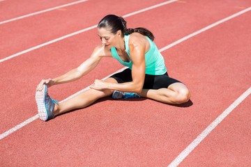 Female athlete stretching her hamstring