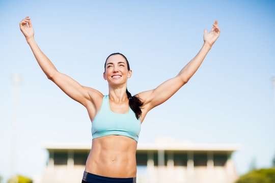 Happy female athlete posing after a victory