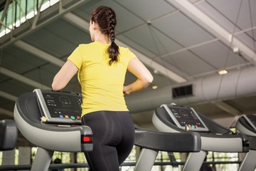 Fototapeta na wymiar Woman jogging on treadmill