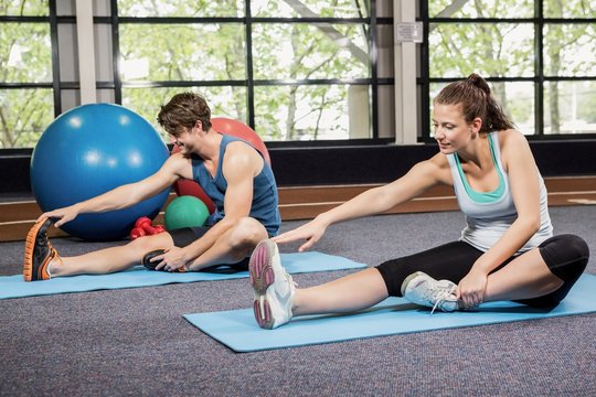 Man and woman performing fitness exercise