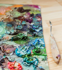 artist brushes, palette knife and palette with paints impression