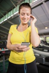Woman listening to music on treadmill