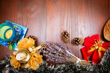 New Year background Christmas tree candle candlestick cone beam lavender bow on the surface of the brown wooden boards
