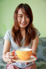 Asian woman relaxing hot coffee.