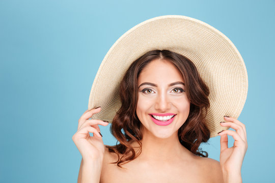 Close-up portrait of brunette wearing beach hat and swimsuit