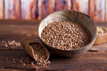 Buckwheat in bowl on wooden table