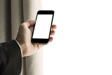 Businessman using mobile phone with curtain opened. and copy space