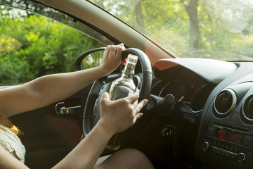 Woman drinking alcohol in the car.