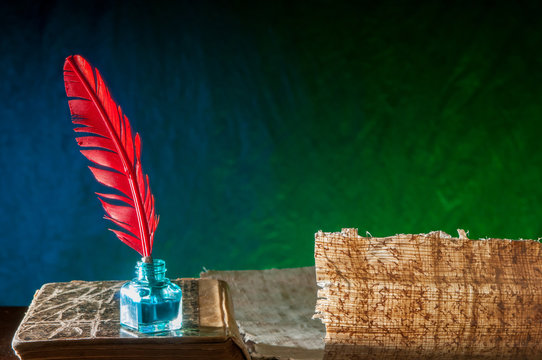 Backlit quill pen and papyrus sheet