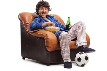 Tuinposter Joyful man watching football on TV © Ljupco Smokovski