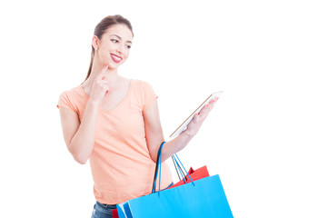 Online shopping concept with woman holding tablet and paper bags