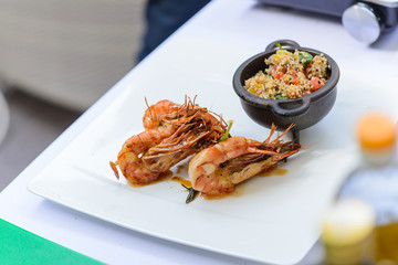 grill chrimps with couscous on plate