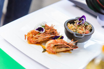 Couscous and shrimps decorated flowers of violets