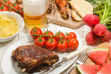 barbecue party with beer, meat and vegetables
