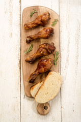 with barbecue sauce marinated chicken drumsticks on wooden board