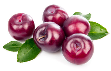 Fresh plums with green leaves still life