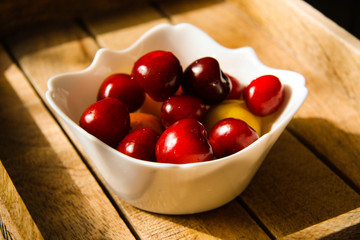 A bowl of cherries and apricots