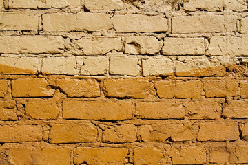 Colorful (beige and yellow) brick wall as background, texture