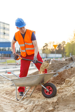 Young worker loading a wheelbarrow