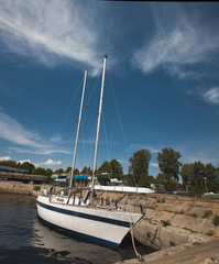 white yacht on the background of blue sky