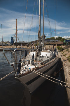 a sailboat moored to the shore