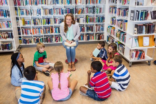 Teacher reading books to her students