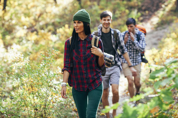 Young woman hiking with friends in forest
