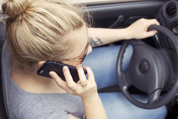 Woman making a phone call while driving