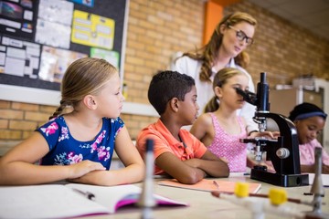 Teacher giving lesson to her students