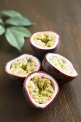 Passion fruit with green leaves on wooden desk