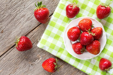 Strawberries on  checkered napkin.