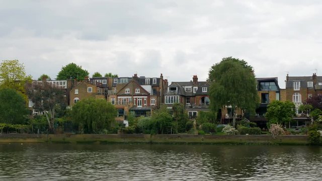 Dolly view of a typical English riverside village in West London