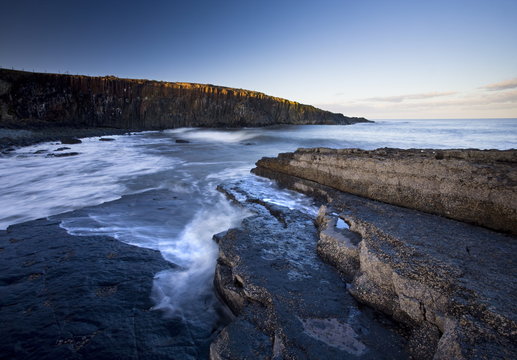 Cullwernose Point bathed in late afternoon light with incoming tide, near Howick, Northumberland
