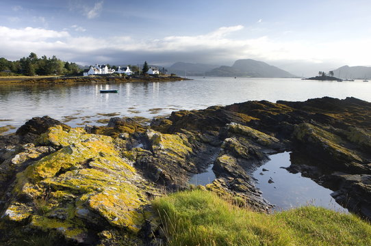 Early morning view of Plokton with houses and foreshore bathed in sunlight, Plokton, near Kyle of Lochalsh, Highland, Scotland