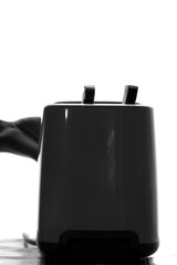 Obraz premium silhouette of a toaster with toast bread on the table